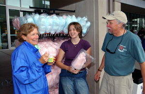 Steve Kohler, medical public affairs, takes a break from setting up signs to enjoy some cotton candy and Ted Drewes ice cream specially made for the Sesquicentennial with his wife, Peggy, and daughter Roxanne.