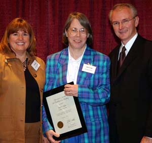 Flanked by Victoria L. May, director of the University's Science Outreach Office, and then-Gov. Bob Holden, Sarah C.R. Elgin, Ph.D.,receives a 2004 Governor's Award for Excellence in Teaching Dec. 1 at the Holiday Inn Executive Center in Columbia, Mo.