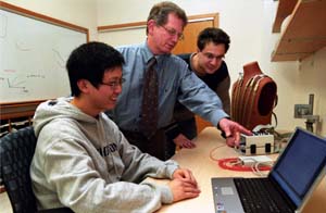 Professor Yoram Rudy (center), with Ph.D. student Yong Wang (left) and post-doctroal fellow Leonid Livshitz (right), with their ECGI system on a mannequin, comment on the cardiac data.