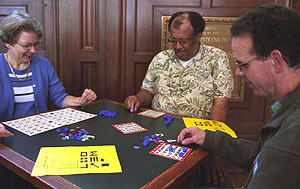 (From left) Judy Fox, Stanley Drane and Phil Corpening, all of Olin Library, play bingo in Holmes Lounge.