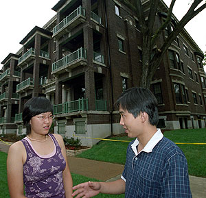 Ziyan Zhang and Yanjiao Xie, both of Peking University, visit outside the two furnished apartment buildings at Pershing Avenue and Skinker Boulevard where most of the McDonnell Academy scholars reside.