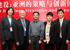 (From left) WUSTL’s Li Zou and Michael Sherraden, PhD, at the November conference in Beijing with partner university officials Wang Sibin of Peking University; Ku Hok-Bun of Hong Kong Polytechnic University; and Deng Suo of Peking University.