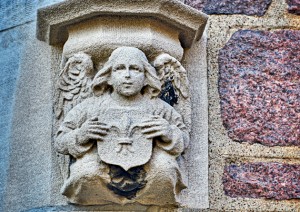 MCMILLAN HALL: A contrasting pair of angels have rested on a McMillan Hall archway since 1906. Above is one of the two. (Photo: James Byard)