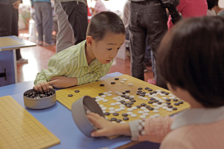 Young Go players in a school in Tianjin China a boy stares at the board astonished.