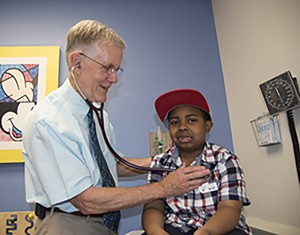 Robert Strunk, MD, examines LeBron Reed, a patient with asthma. Strunk, of Washington University School of Medicine in St. Louis, led a study showing the importance of children with asthma maintaining healthy weight as they grow into young adults. Photo: Robert J. Boston