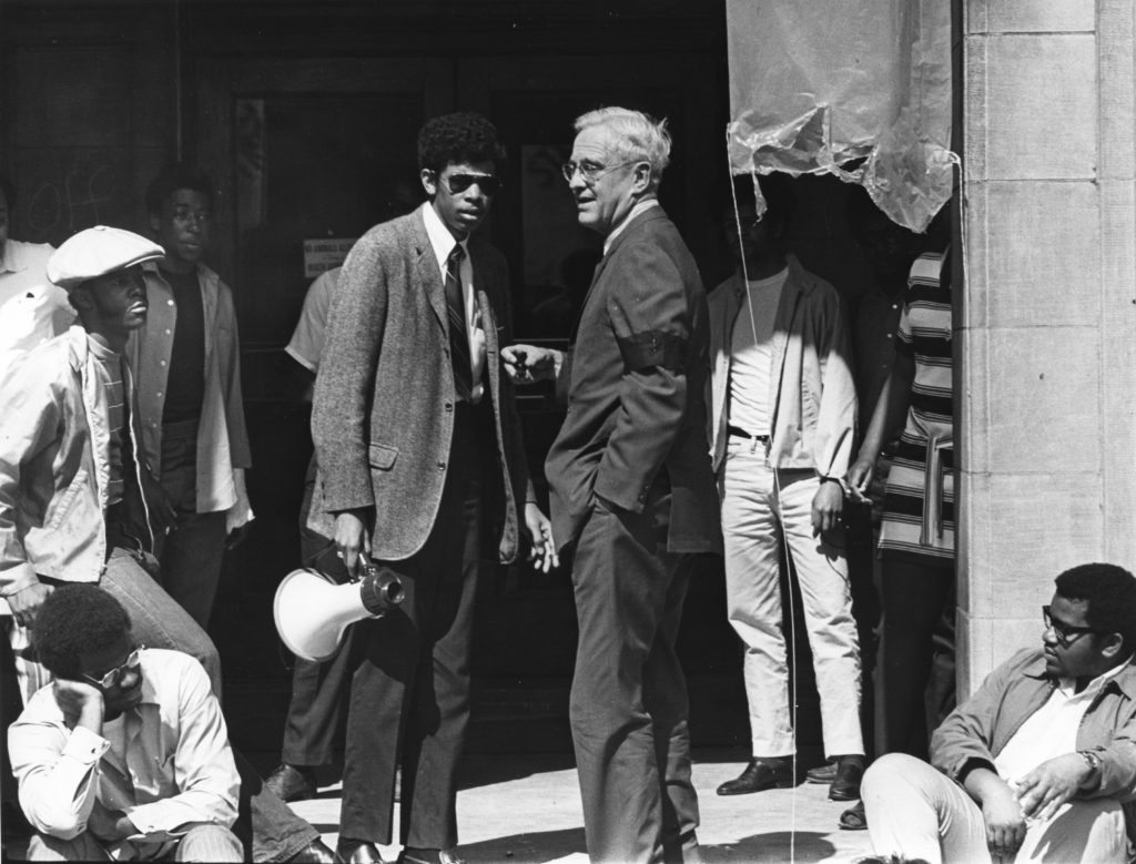 Student William Pollard III (pictured with megaphone) speaks with Chancellor Thomas H. Eliot in 1968. Pollard, who earned his bachelor's degree in political science in 1970, was honored as a distinguished alumni at Founders Day in 2007. He is currently a member of the Arts & Sciences National Council. (Washington University Archives) 