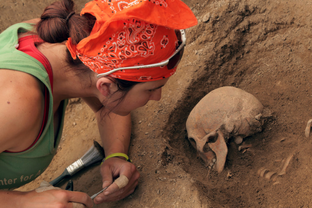 Washington University graduate student Elissa Bullion uncovers an ancient skull from a burial plot at the Medieval city of Tashbulak in Uzbekistan.