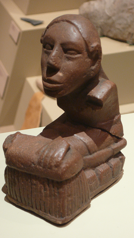 The Keller figurine, one of several flint-clay statues from the Mississippian mound-building culture unearthed at Cahokia, Ill., is seen by some scholars as ‘corn goddess’ sitting on rows of corn cobs. Others, such as Gayle Fritz of Washington University in St. Louis, suggest that the figurine is more representative of the “old mother” character common among more Souan tribes of the upper Missouri River, such as the Mandan and Hidatsa. Photo by Tim Vickers via Wikipedia Commons.