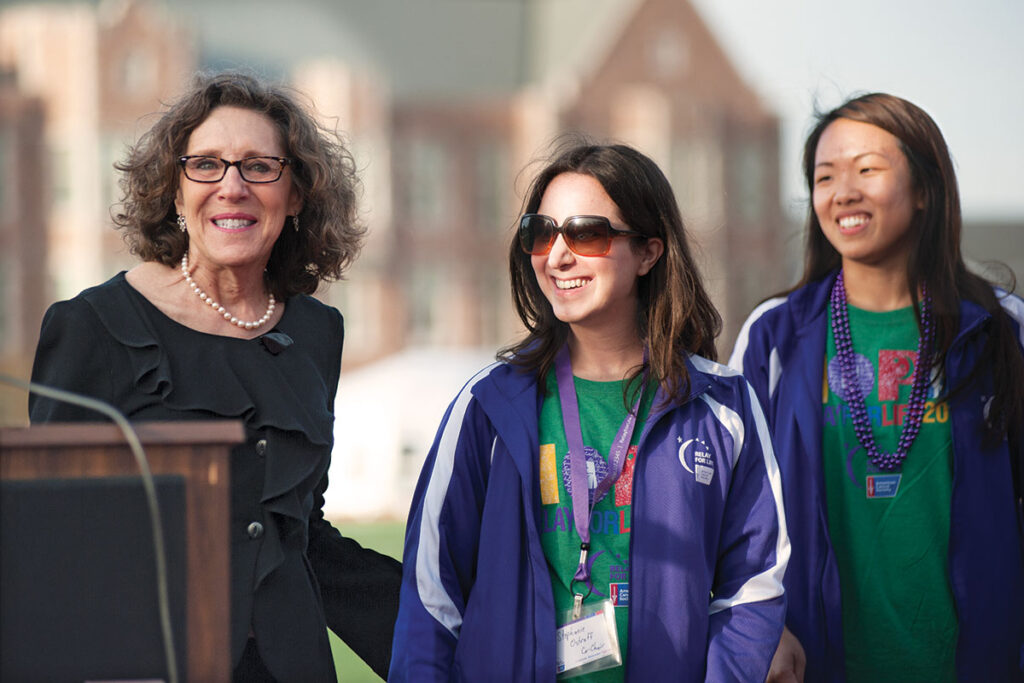 Risa joins students and other members of the community in the annual Relay for Life, a fundraiser for the American Cancer Society. Here she's pictured (far left) at the 2015 event with relay co-chairs Connie Ho (left) and Stephanie Ostroff during the opening ceremonies. Photo by Sid Hastings / WUSTL Photos