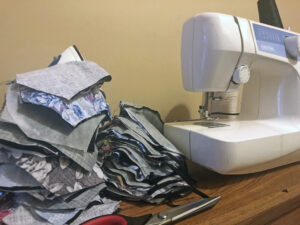 Sewing machine and partially-completed masks