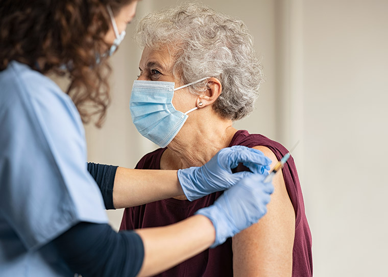 Elderly woman getting a vaccine