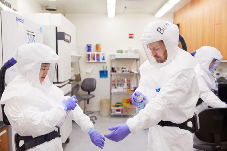 researchers prepare to work with SARS-CoV-2