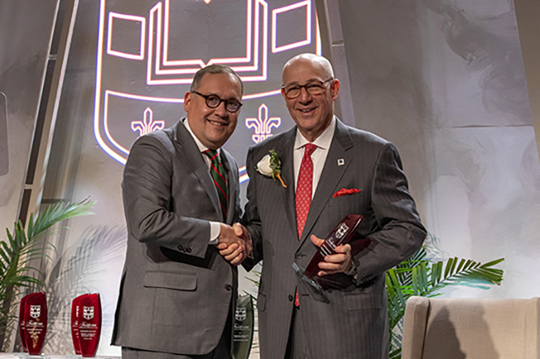 Chancellor Andrew D. Martin congratulates Timothy J. Eberlein, MD, on his Distinguished Faculty Award at the university's Founders Day ceremony. (Photo: Joe Angeles/Washington University)