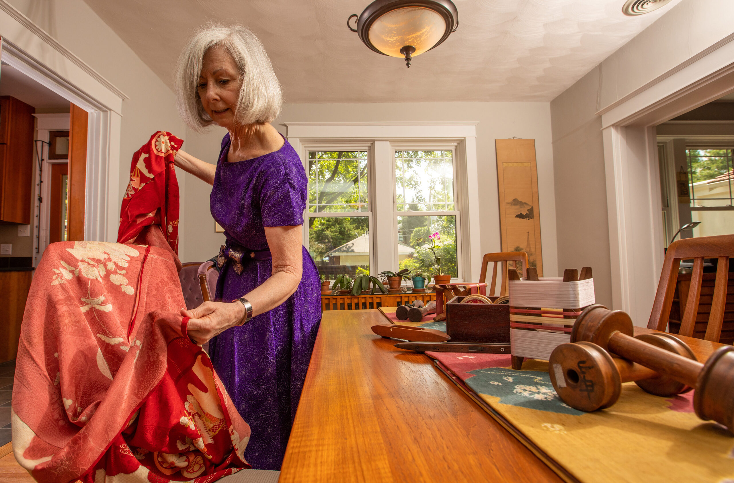 prof copeland inspects some of her kimono collection items on