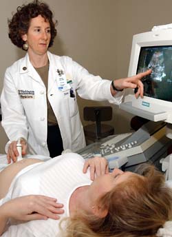 Diana L. Gray, M.D., professor of obstetrics and gynecology and of radiology and associate dean for faculty affairs, administers an ultrasound to patient Patricia Wells, who is pregnant with a baby boy. 