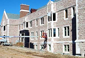 Construction work continues on the Earth and Planetary Sciences Building just north of Brookings Hall. The roofing is being completed to provide dry conditions for interior work, and partition framing continues on all levels. Drywall work will soon begin in the lower level.