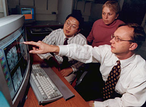 John G. Csernansky, M.D. (right), shows a brain image to Lei Wang, Ph.D., and Deanna M. Barch, Ph.D., in the Silvio Conte Center for Neuroscience Research.