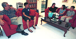 Stamos Metzidakis, Ph.D. (left), professor of French and of comparative literature, both in Arts & Sciences, and wife Sarah (center) chat with students (from left) Andrew Sapthavee, Jenny Tuan and Wayne Chuang in the Metzidakis' apartment in the Park/Mudd Residential College. The Metzidakises are the newest faculty family on the South 40.