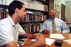James Herbert Williams, Ph.D. (right), the E. Desmond Lee Professor of Racial and Ethnic Diversity and associate dean for academic affairs in the George Warren Brown School of Social Work, talks with Kuyosh Kadirov, a first-year master of social work student and an Open Society Institute fellow from Uzbekistan.