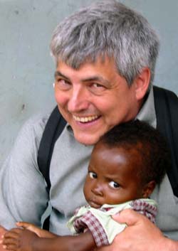 Mark Manary, M.D., associate rofessor of pediatrics, bonds with a Peanut Butter Project patient.