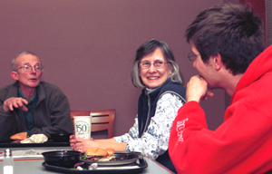 (From left) James W. Davis, Ph.D., professor of political science in Arts & Sciences and faculty associate at the Village, and his wife, Jean, chat with sophomore Ethan Ardi recently during Davis' regular dinner with students. In addition to the dinners, Davis has worked to create several 