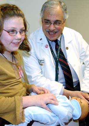 Neil H. White, M.D., director of the Division of Pediatric Endocrinology and Metabolism, examines diabetes patient Miranda Baalman. 
