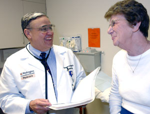 Gregorio Sicard, M.D., reviews vascular patient Geraldine Gehr's chart during a routine checkup. 