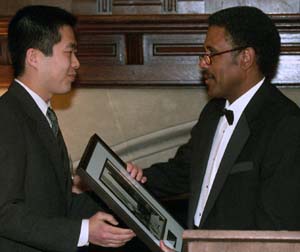 Medical student Edy Yong Kim (left) receives a Sesquicentennial Ethic of Sevice Award from James E. McLeod, vice chancellor for students and dean of the College of Arts & Sciences. Kim was one of six University community members to be honored for their outstanding character of service to the St. Louis region.