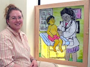 Victoria Sher, a senior ceramics major in the School of Art, shows off one of three hand-painted windows she created for patient examination rooms at Grace Hill's Soulard Neighborhood Health Center.