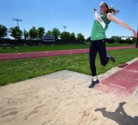 At the University's historic Francis Field, Lindsey Clark-Ryan demonstrates the form that made her an All-University Athletic Association jumper and a five-time NCAA provisional qualifier. An award-winning School of Art student, she also majored in English in Arts & Sciences.