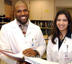 Medical students Jason Stephenson and Heba Iskandar review a diabetes patient's chart at Barnes-Jewish Hospital. 