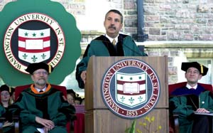 John F. McDonnell, left, chairman of WUSTL's board of trustees, and Chancellor Mark S. Wrighton look on as Thomas L. Friedman, the foreign affairs columnist at *The New York Times*, delivers his Commencement address, titled 