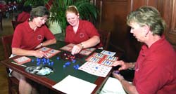Above (from left) Pat Smith, Stacy Seibert and Cathy Jo Hanson enjoy a game of bingo in Holmes Lounge on Staff Day.
