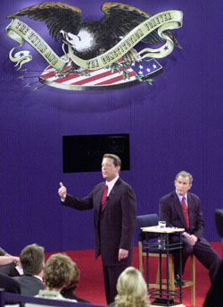 Former Vice President Al Gore (left) and Texas Gov. George W. Bush (seated, right) face off in the third Presidential Debate in the Field House at WUSTL.