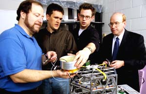 Junior David Corley (left) gets an opportunity to work with the School of Engineering & Applied Science's (from left) Michael A. Swartwout, Ph.D., assistant professor of mechanical engineering; Jared G. Macke, a first-year graduate student; and Keith J. Bennett, adjunct assistant professor of computer science and engineering, recently during a NASA-sponsored competition in Lopata Hall. The new Office of Undergraduate Research will make it easier for undergraduates like Corley to locate research opportunities.