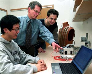 Yoram Rudy, Ph.D. (center), with doctoral student Yong Wang (left) and postdoctoral fellow Leonid Livshitz, discuss cardiac data received from their electrocardiographic imaging system (seen on the mannequin torso at right).