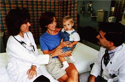 Dr. Mario Castro and nurse Michelle Jenkerson visit with RBEL study patient and RSV infection survivor Wil Klages and his mom, Peg Klages.