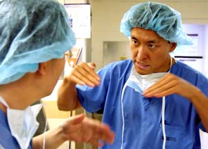 Dan Riew, M.D., associate professor of orthopaedic surgery and chief of cervical spine surgery, discusses a case with an orthopaedic surgery resident outside the OR. 