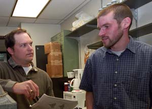 Doctoral candidates Brian Langerhans (left) and Liam Revell discuss research. Langerhans specializes in the study of ecological factors that shape the evolution of body forms.