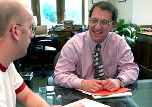 Edward F. Lawlor, Ph.D. (right), chats with first-year master of social work student Scott Wilson. Lawlor is dean of the George Warren Brown School of Social Work and the William E. Gordon Professor. 