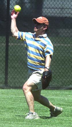George Warren Brown School of Social Work Dean Eddie Lawlor guns the ball in from the outfield.