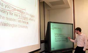 DJ Kaiser demonstrates a new SMARTBoard, which allows the professor to interact with the touch-sensitive whiteboard surface using his or her hand as a mouse and the presentation screen as a computer monitor.