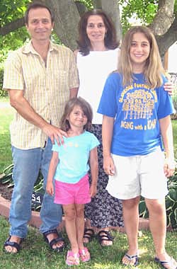 Martin Cripps with his wife, Louise, and daughters Grace, 13, and Daisy, 5, outside their home.