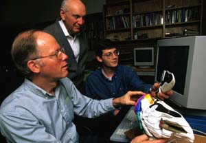 David Van Essen, Ph.D. (left), discusses parts of the brain with colleagues. Van Essen is the fourth University neuroscientist to be elected president of the Society for Neuroscience.