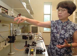 Alian Wang, Ph.D., makes adjustments to equipment in her laboratory. Wang and three others from the Department of Earth and Planetary Sciences in Arts & Sciences recently published the first solid set of evidence for water having existed on Mars at the Gusev crater, a site that the rover Spirit explored.