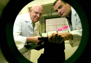 Michael J. Welch, Ph.D. (left), and Jason S. Lewis, Ph.D., set up the microPET scanner for an imaging experiment. 