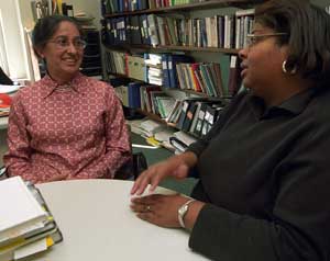 Shanta Pandey, Ph.D. (left), talks with single mom and first-year master of social work student Tiffany Powell. Pandey focuses her research on how powerful education is in reducing poverty and what policy changes need to be made to encourage higher education for single mothers.