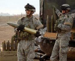 Soldiers currently stationed at Camp Liberty, Iraq, unload 105mm M119 Howitzer rounds.