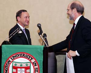 Chancellor Mark S. Wrighton shakes hands with John F. McDonnell, vice chairman of the Washington University Board of Trustees, during the Oct. 19 announcement of the McDonnell International Scholars Academy.