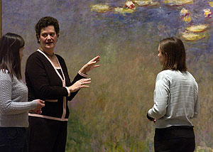 Elizabeth Childs, Ph.D., associate professor of art history & archaeology in Arts & Sciences, examines Monet's *Water Lilies* at the Saint Louis Art Museum with master's candidate Sarah McGavran (left) and doctoral candidate Noelle Paulson Bradley.